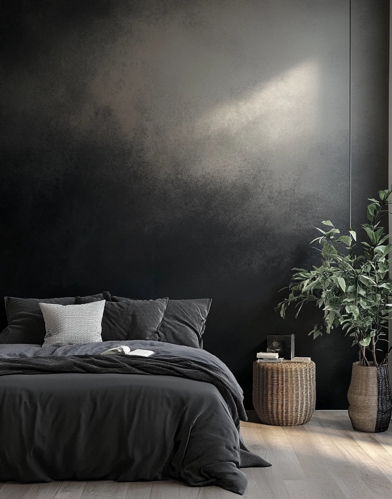 Charcoal black color tile wall in bedroom with dark linens and plant.