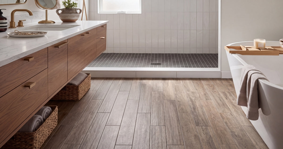 Wood-look bathroom flooring idea: Selection Oak Amber Grip R11 plank tile in a spa bathroom with freestanding tub and walk-in shower