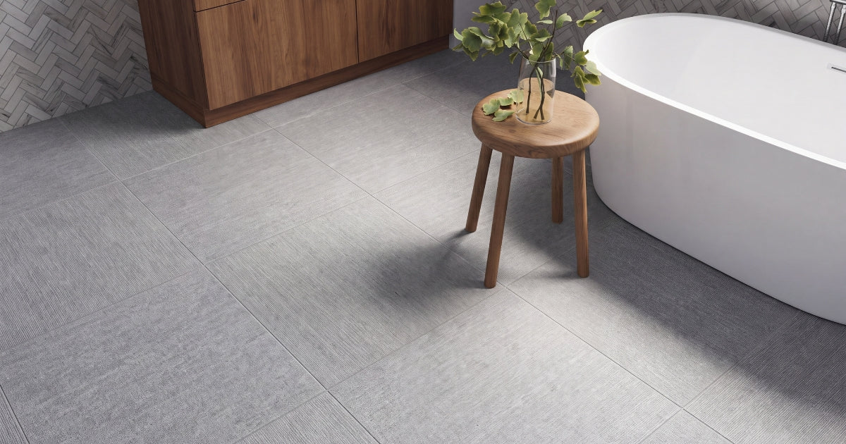 Grey bathroom floor idea: Elevation Grey 24x24 matte tile in a minimalist bathroom with a wood vanity and black fixtures