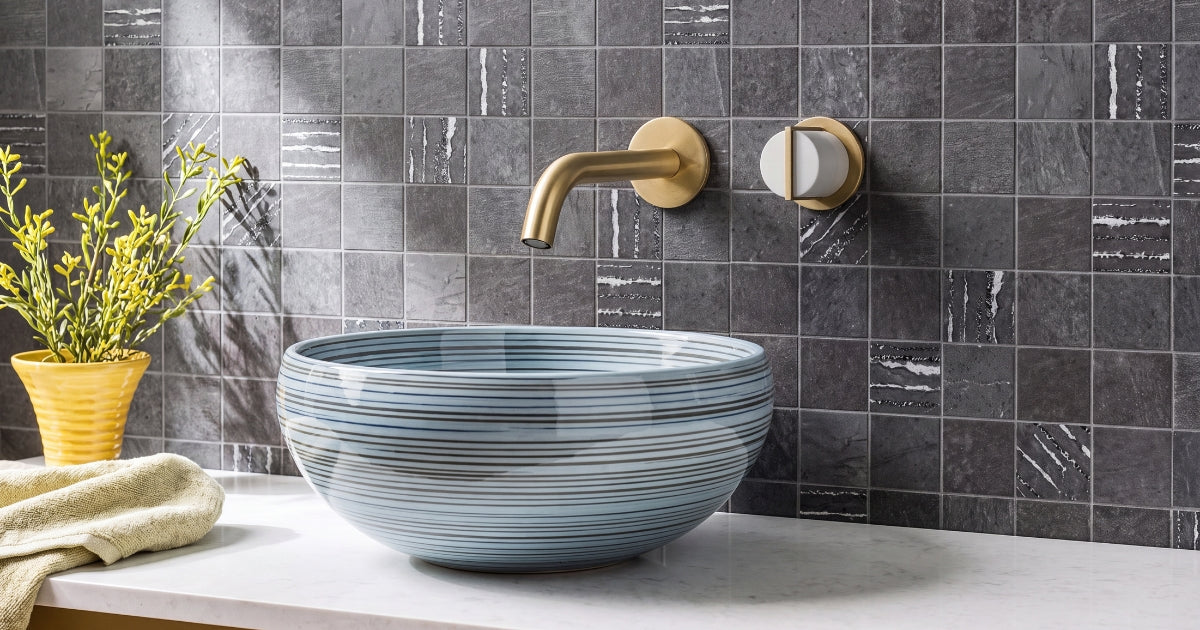 Dark stone mosaic accent idea: Sunstone Basalt charcoal mosaic contrasting against a light bathroom vanity